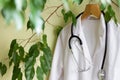 Alternative medicine concept with green tree and doctor coat