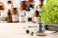 Alternative medicine concept medicine in bottles, medicinal herbs and stethoscope on a wooden table Royalty Free Stock Photo