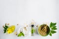 Alternative medicine, herbal extract: white background, hands hold a jar of oil over a bowl with white essence, and stirring. Bowl Royalty Free Stock Photo