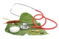 Alternative medicine herbs and stethoscope on leaf Royalty Free Stock Photo