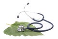 Alternative medicine herbs and stethoscope on leaf Royalty Free Stock Photo