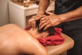 Alternative Medicine. Woman lying face down while therapist doing head and neck massage presing on meridians close-up