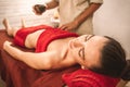 Alternative Medicine. Therapist healing lying woman closed eyes relaxed close-up doing massage with aroma candle