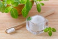 Alternative natural toothpaste xylitol, soda, salt, and wood toothbrush closeup, mint on wooden Royalty Free Stock Photo