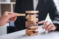 Alternative Risk and Strategy in Business, Hand of business team cooperative gambling placing making wooden block hierarchy on the Royalty Free Stock Photo