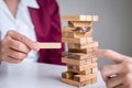 Alternative Risk and Strategy in Business, Hand of business team cooperative gambling placing making wooden block hierarchy on the Royalty Free Stock Photo