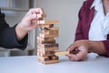 Alternative Risk and Strategy in Business, Hand of business team cooperative gambling placing making wooden block hierarchy on the Royalty Free Stock Photo