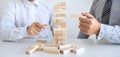 Alternative Risk and Strategy in Business, Hand of business team cooperative gambling placing making wooden block hierarchy on the Royalty Free Stock Photo