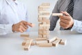 Alternative Risk and Strategy in Business, Hand of business team cooperative gambling placing making wooden block hierarchy on the Royalty Free Stock Photo