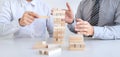 Alternative Risk and Strategy in Business, Hand of business team cooperative gambling placing making wooden block hierarchy on the Royalty Free Stock Photo