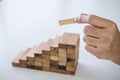 Alternative Risk and Strategy in business to make growth, Image of Business man`s hand placing making a wooden block stacking