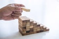 Alternative Risk and Strategy in business to make growth, Image of Business man`s hand placing making a wooden block stacking