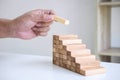 Alternative Risk and Strategy in business to make growth, Image of Business man`s hand placing making a wooden block stacking