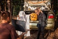 Online Halloween celebration. Kids scaring friends via internet at themed party in trunk of car