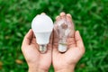 Alternative technology concept . Hands holding LED Bulb and Fluorescent bulb comparing in hands Royalty Free Stock Photo