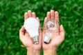 Alternative technology concept . Hands holding LED Bulb and Fluorescent bulb comparing in hands Royalty Free Stock Photo