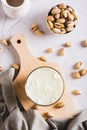 Alternative vegetarian pistachio milk in a glass and nuts on the table top and vertical view Royalty Free Stock Photo