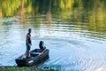 Althom, Pennsylvania, USA 8/10/2019 A man standing on a boat on the shore of the Allegheny river in Warren county