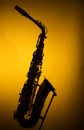 Alto Saxophone in Silhouette on Yellow Royalty Free Stock Photo