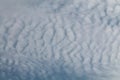 Altocumulus undulatus cloud. Sky with white wavy clouds Royalty Free Stock Photo