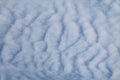 Altocumulus undulatus cloud. Sky with white wavy clouds Royalty Free Stock Photo