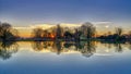 Reflections of St Leonard`s church in Hartley Mauditt Pond, South Downs National Park, UK