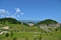 Landscape with biathlon base at the Fundata Resort at Cheile Gradistei with Piatra Craiului Mountains in the background. Royalty Free Stock Photo