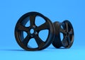 Aluminium alloy car wheel. Black alloy rim for car, tracks on blue background Royalty Free Stock Photo