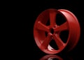 Aluminium alloy car wheel. Red alloy rim for car, tracks on black background
