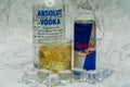 Aluminium can of Red Bull Energy drink with ice and drops, Vodka Absolut. Red Bull is the most popular energy drink in the world. Royalty Free Stock Photo