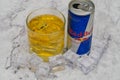 Aluminium can of Red Bull Energy drink with ice and drops, Vodka Absolut. Red Bull is the most popular energy drink in the world. Royalty Free Stock Photo
