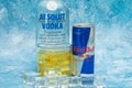 Aluminium can of Red Bull Energy drink with ice and drops, Vodka Absolut. Red Bull is the most popular energy drink in the world. Royalty Free Stock Photo