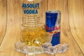 Aluminium can of Red Bull Energy drink with ice and drops, Vodka Absolut. Red Bull is the most popular energy drink in the world. Royalty Free Stock Photo