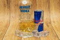 Aluminium can of Red Bull Energy drink with ice and drops, Vodka Absolut. Red Bull is the most popular energy drink in the world. Royalty Free Stock Photo