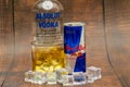 Aluminium can of Red Bull Energy drink with ice and drops, Vodka Absolut. Red Bull is the most popular energy drink in the world. Royalty Free Stock Photo