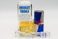 Aluminium can of Red Bull Energy drink with ice and drops, Vodka Absolut. Red Bull is the most popular energy drink in the world. Royalty Free Stock Photo