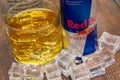 Aluminium can of Red Bull Energy drink with ice and drops, Vodka Absolut. Red Bull is the most popular energy drink in the world. Royalty Free Stock Photo