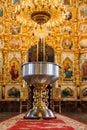 Aluminium church font, large bowl, with golden cross and saint water for the baptism of babies in Orthodox Church temple Royalty Free Stock Photo