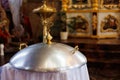 Aluminium church font, large bowl, with golden cross and saint water for the baptism of babies in Orthodox Church temple