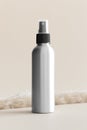 Aluminium cosmetic spray bottle mockup on the soft yellow background