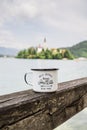 Aluminium mug with coffe, lake view