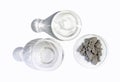 Aluminium powder in Chemical Watch Glass place next to Erlenmeyer flask and Flat Bottom Flask on white laboratory table. Top View Royalty Free Stock Photo