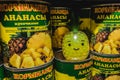 Aluminium tin can with chopped canned pineapple and toy in a shape of pineapple among the tins. it is