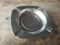 Aluminum Ashtray on wooden table. Aesthetic and traditional. Anchient, vintage, old school, retro. Focus