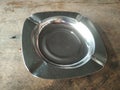 Aluminum Ashtray on wooden table. Aesthetic and traditional. Anchient, vintage, old school, retro. Focus