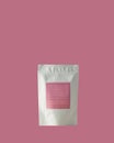 Aluminum bag for tea, coffee, condiments and other bulk substances with pink label for signature on pink background Royalty Free Stock Photo