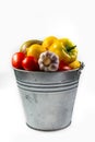 .Aluminum bucket with assortment of fresh vegetables on white background Royalty Free Stock Photo