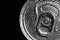 Aluminum can of beverage covered with water drops on black background. Space for text Royalty Free Stock Photo