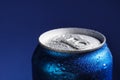 Aluminum can of beverage  with water drops on blue background, closeup. Space for text Royalty Free Stock Photo