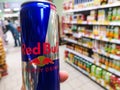 aluminum can of energy drink with caffeine and taurine Red Bull in a grocery store against the background of counter 11